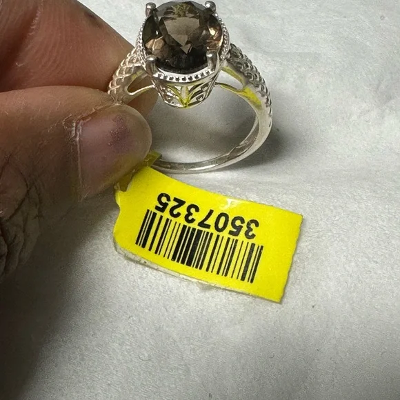 This is a sterling silver ring featuring a smoky quartz gemstone